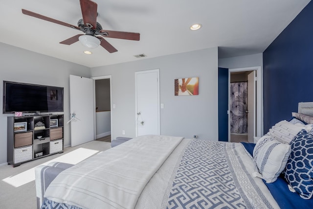 bedroom with ceiling fan and light carpet