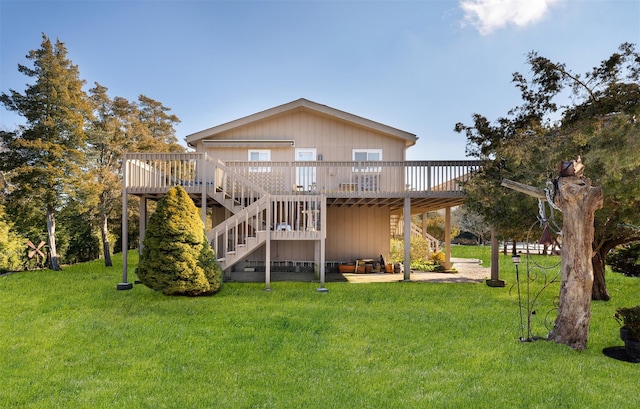 rear view of house with a wooden deck and a yard