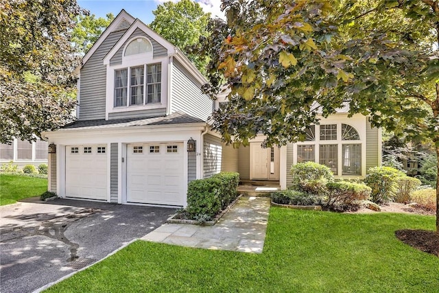 view of front facade featuring a garage and a front lawn