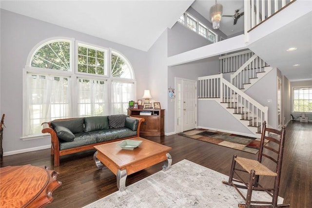 living room featuring dark wood-type flooring and high vaulted ceiling