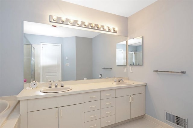 bathroom featuring vanity, shower with separate bathtub, and tile patterned floors