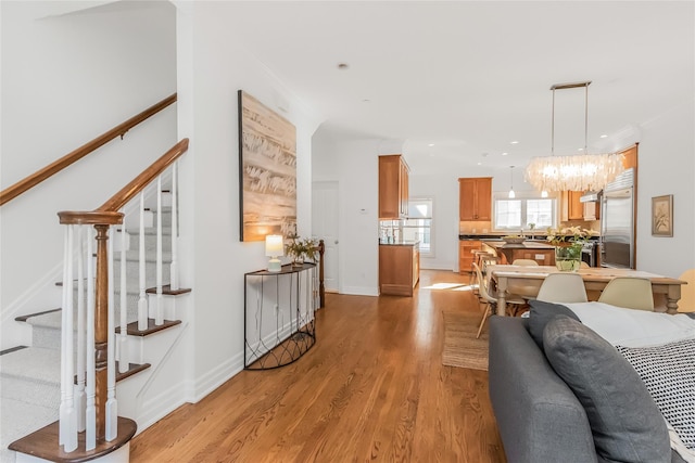 living room with light hardwood / wood-style flooring and ornamental molding