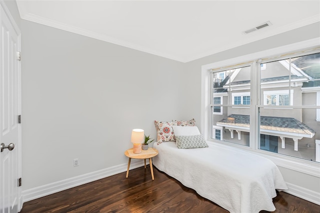 bedroom featuring dark wood-type flooring and crown molding