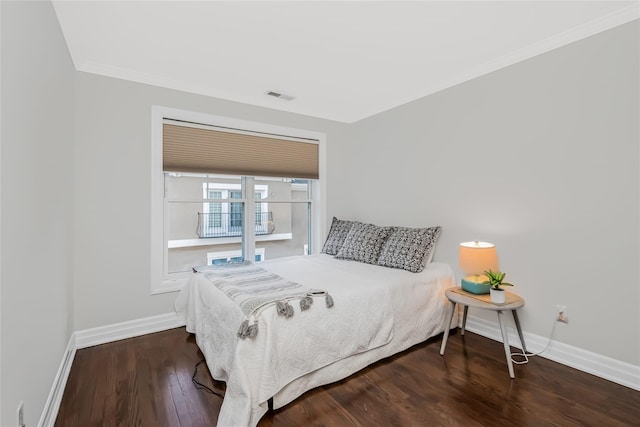 bedroom featuring crown molding and dark hardwood / wood-style floors