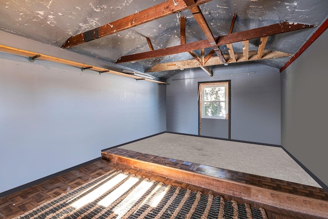 spare room featuring lofted ceiling and parquet floors