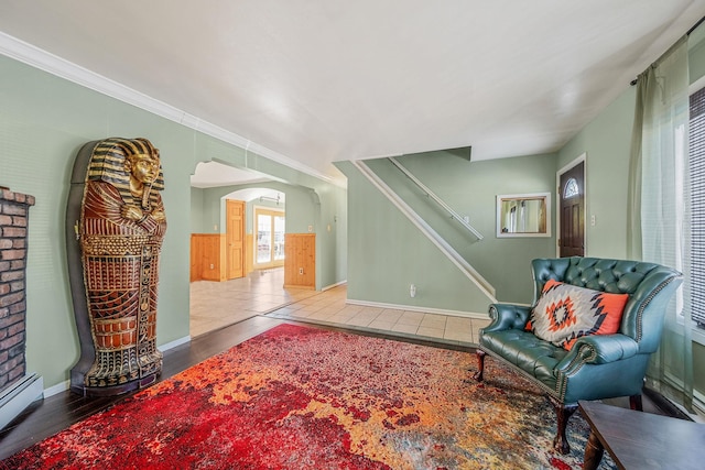 sitting room featuring crown molding, hardwood / wood-style flooring, and a baseboard radiator