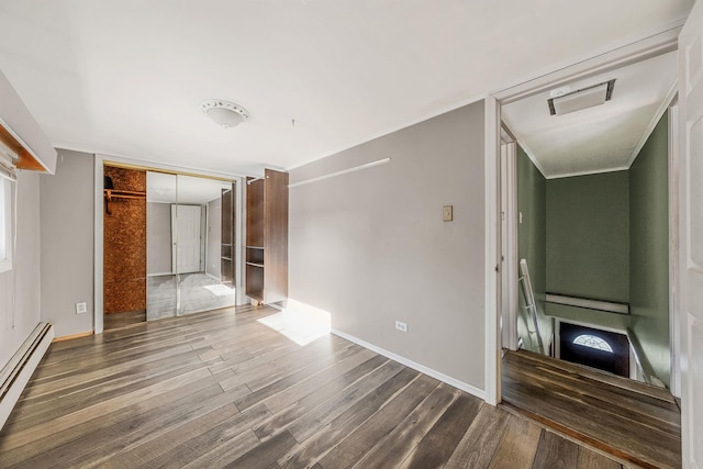 unfurnished living room featuring a baseboard radiator and dark hardwood / wood-style flooring