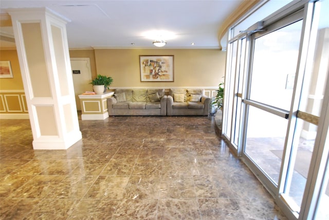 living room with decorative columns and crown molding