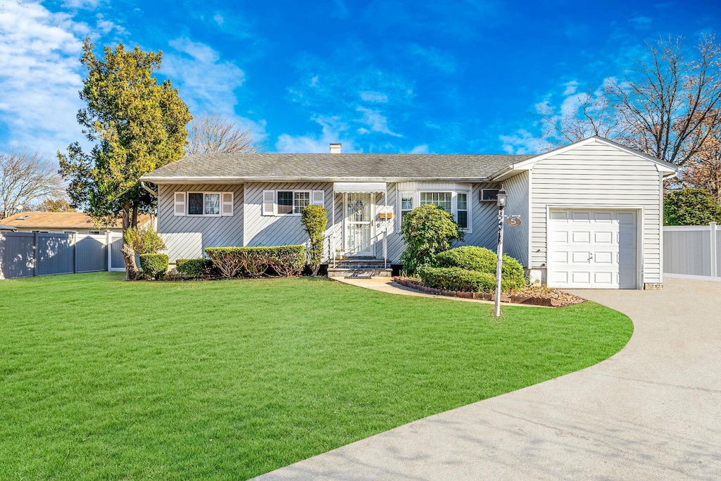 ranch-style house featuring a garage and a front yard