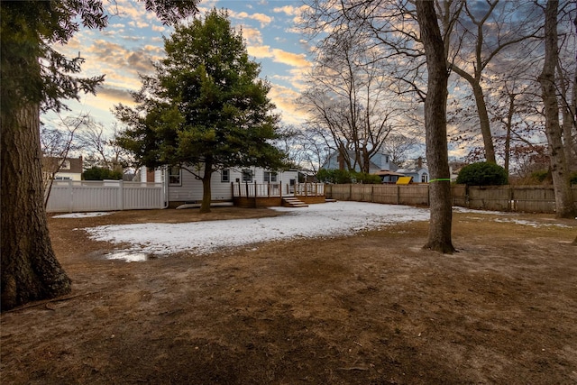 yard at dusk with a wooden deck