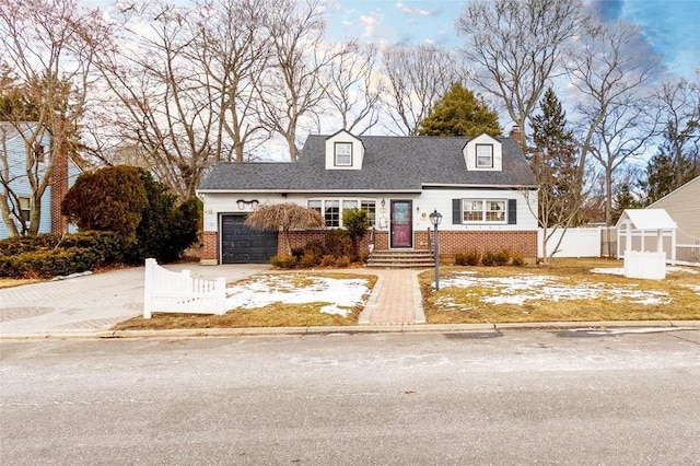 cape cod-style house featuring a garage