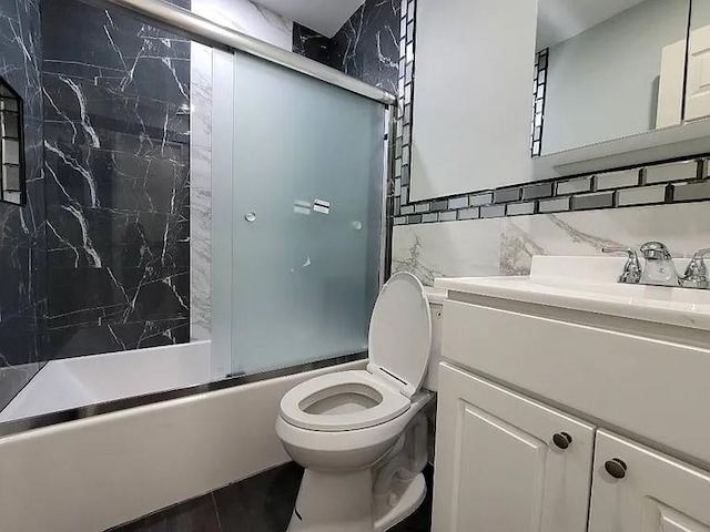 full bathroom featuring toilet, tasteful backsplash, tile walls, vanity, and enclosed tub / shower combo