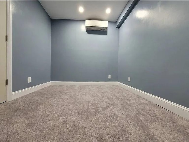 carpeted spare room with a wall mounted AC