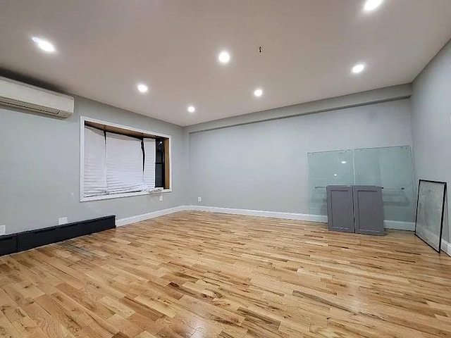 interior space featuring an AC wall unit and light hardwood / wood-style floors