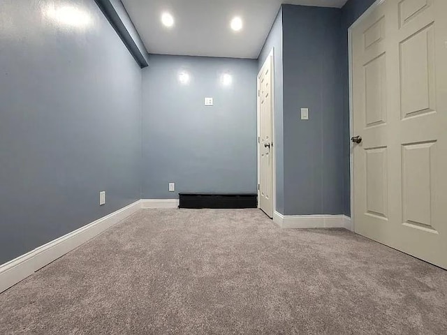 spare room featuring light carpet