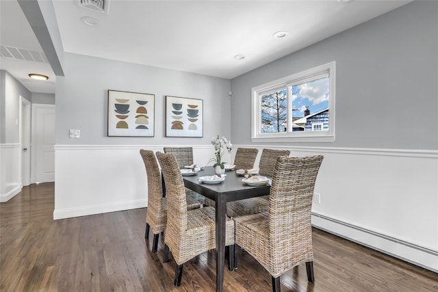 dining room featuring dark hardwood / wood-style floors and baseboard heating