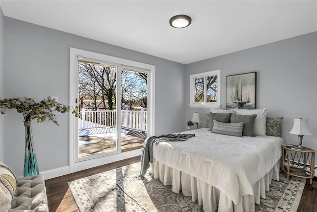 bedroom with dark hardwood / wood-style floors and access to exterior