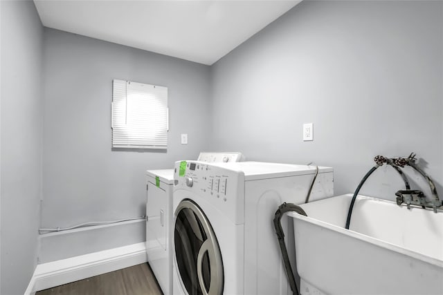 washroom featuring sink, hardwood / wood-style flooring, and independent washer and dryer