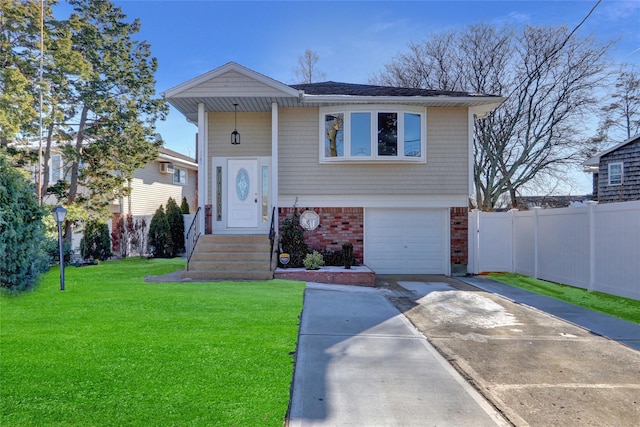 bi-level home featuring a garage and a front lawn