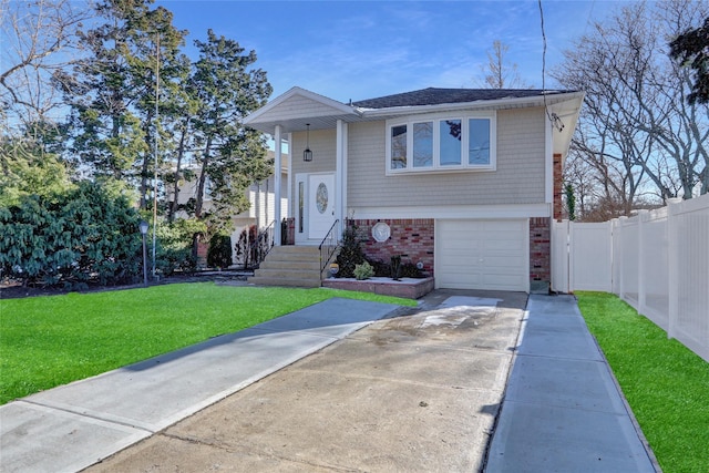 raised ranch with a garage and a front lawn