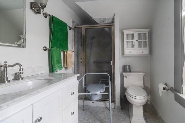 bathroom featuring tile patterned flooring, vanity, toilet, and walk in shower