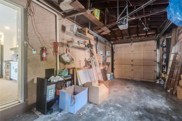 garage with a garage door opener and stainless steel fridge