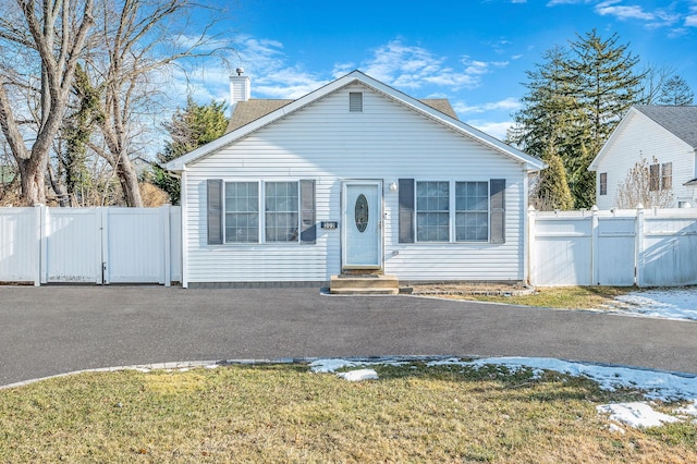 bungalow-style home with a front lawn