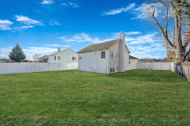 rear view of house featuring a lawn