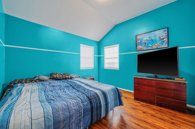 bedroom featuring lofted ceiling and hardwood / wood-style flooring