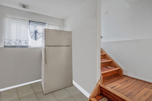 kitchen with tile patterned flooring and white refrigerator