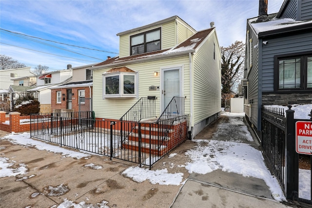 view of front of house with entry steps and fence