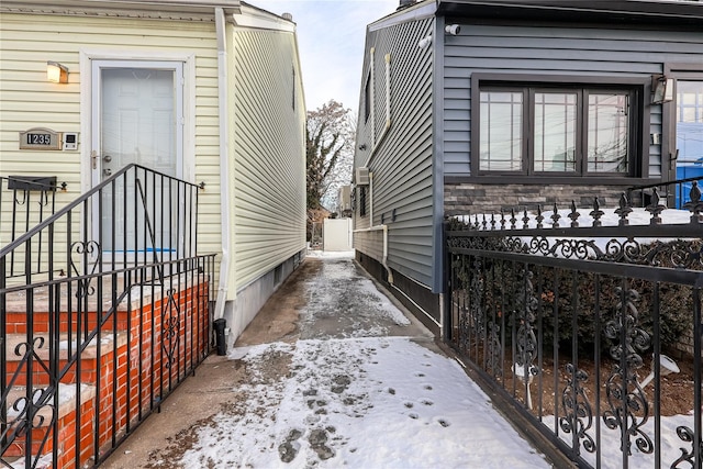 view of snow covered exterior with stone siding