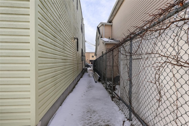 view of side of home featuring fence