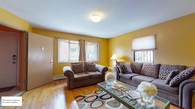 living room with a baseboard radiator and light hardwood / wood-style flooring