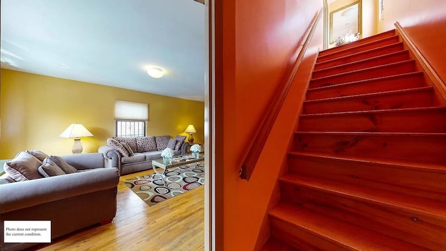 staircase with wood-type flooring