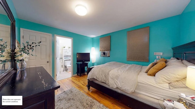 bedroom with ensuite bath and light hardwood / wood-style flooring