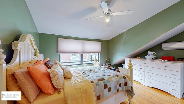 bedroom with lofted ceiling, a wall mounted air conditioner, light hardwood / wood-style floors, and ceiling fan