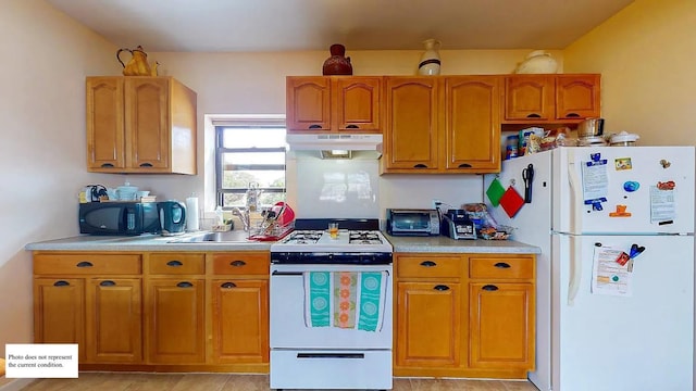 kitchen featuring under cabinet range hood, brown cabinetry, white appliances, and light countertops