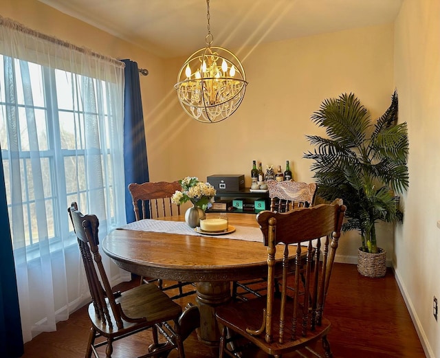 dining room featuring dark wood-type flooring and a notable chandelier