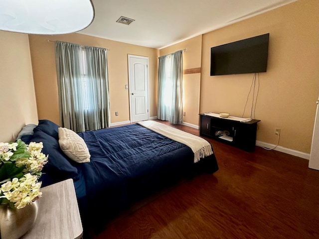 bedroom with dark hardwood / wood-style floors