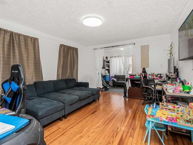 living room with wood-type flooring and a textured ceiling