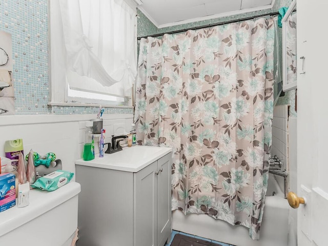 full bathroom with vanity, shower / bath combination with curtain, and toilet