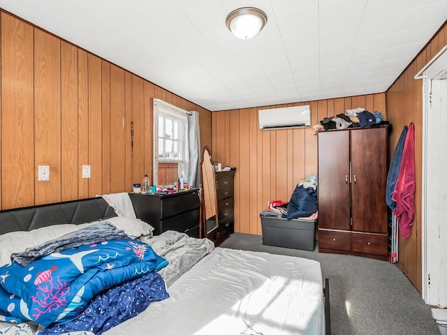 bedroom featuring wooden walls and a wall unit AC