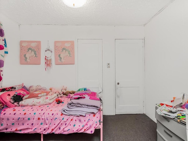 carpeted bedroom featuring a textured ceiling