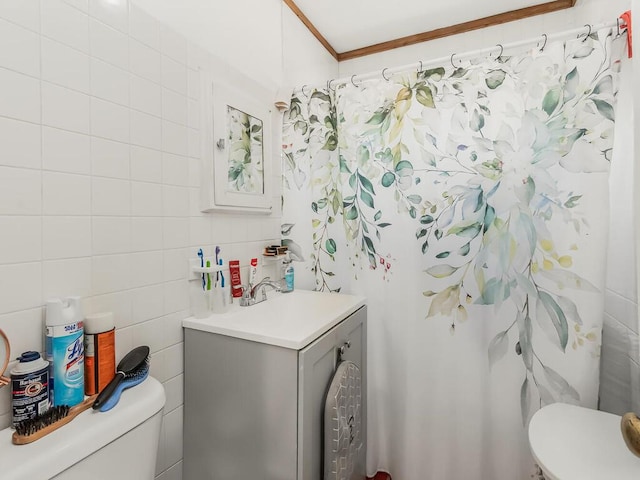 bathroom with walk in shower, toilet, crown molding, tile walls, and vanity