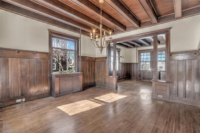 interior space with wood ceiling, a notable chandelier, beam ceiling, and hardwood / wood-style flooring