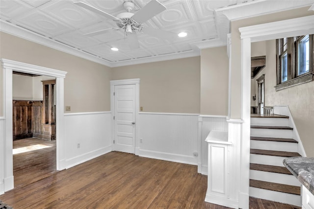 unfurnished room featuring crown molding, dark wood-type flooring, and ceiling fan