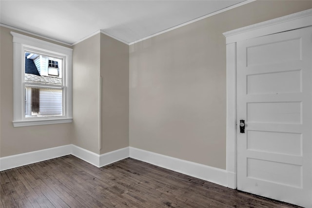 empty room with dark wood-type flooring and crown molding