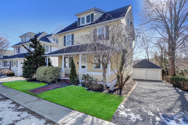 front of property with a porch, a garage, an outdoor structure, and a front yard