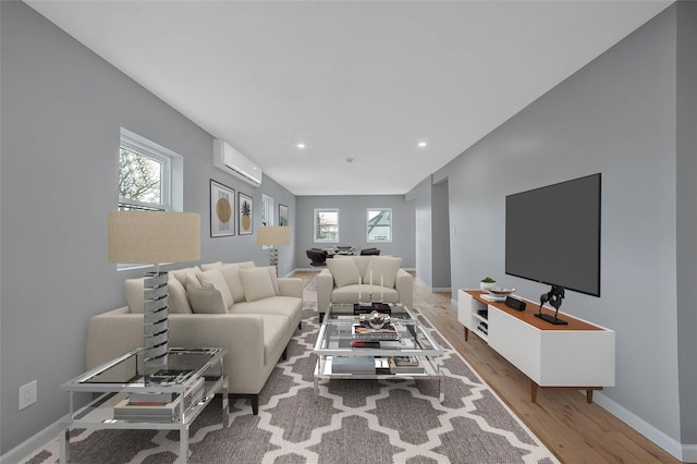 living room with wood-type flooring and a wall mounted AC